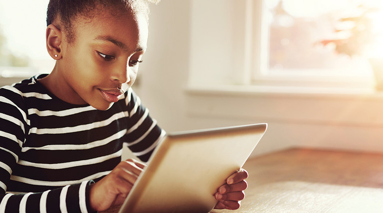 Young girl looking at tablet