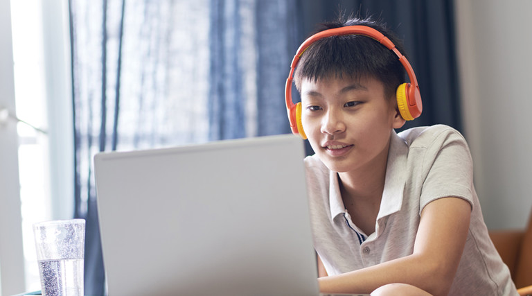 K–12 student watching videos at home in flipped-classroom model